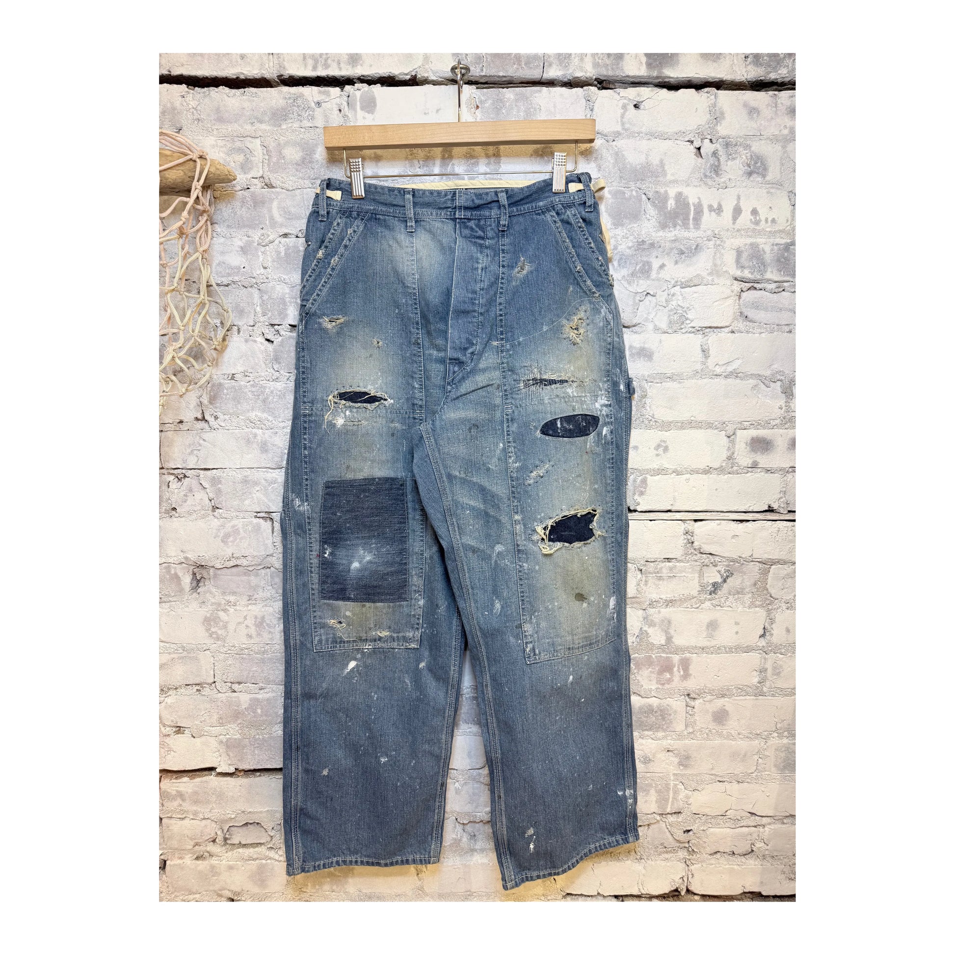 Men's customized side open Panther denim pants by H-Unit with stylish design and unique side openings, displayed on a white background.