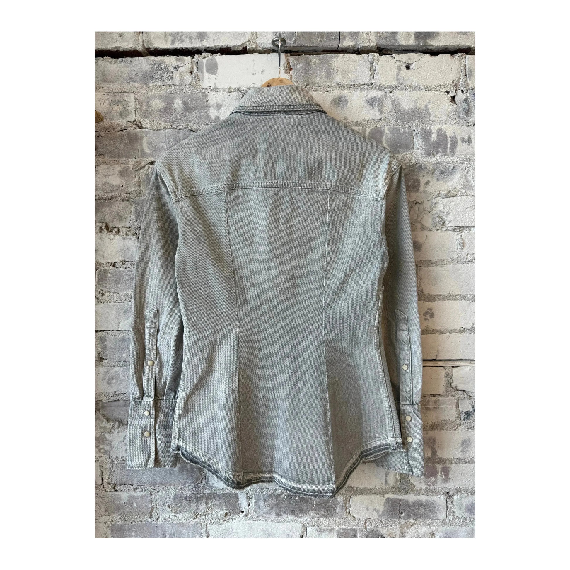 Light grey women's denim shirt by Closed Women's, featuring a classic collar and button-down front, styled on a hanger.