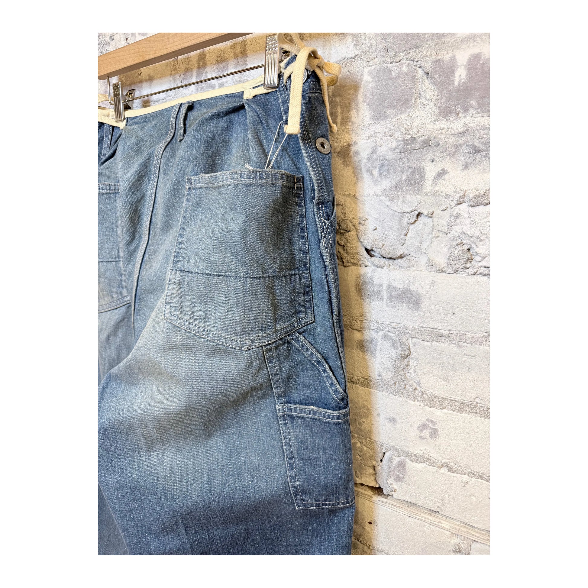 Men's denim painter pants by H-Unit with side opening, used wash, featuring functional pockets and durable workwear design.