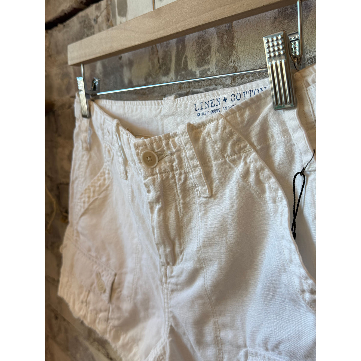 Women's white G1 drill shorts, casual fit with adjustable waistband and pockets, shown on a model.