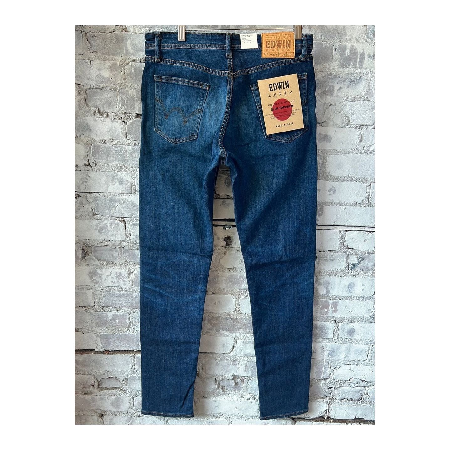 Men's Edwin Aomori Slim Taper Denim jeans in dark indigo with subtle fading, showcasing the fitted style and classic denim texture.