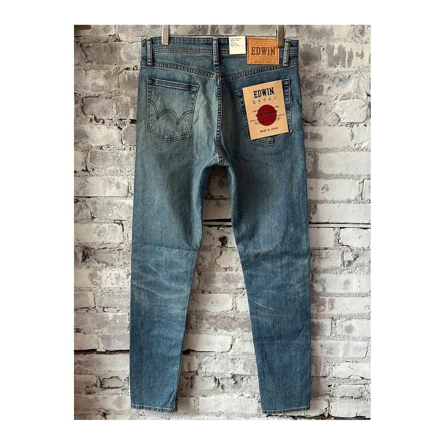 Men's Edwin Aomori Slim Taper Denim jeans in Raito color, showing a close-up of the dark indigo fabric and tapered fit.