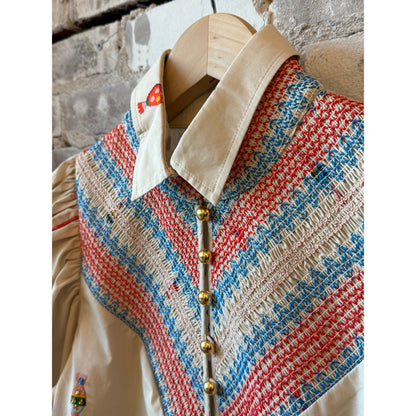 Women's embroidered smocked shirt in vanilla with colorful floral embroidery, by Hope For Flowers, showing intricate embroidery details.