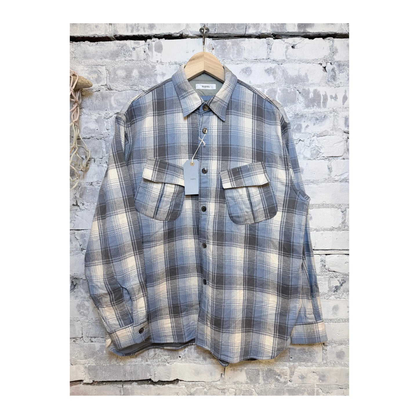 Men's blue check Fatigue Flannel Shirt by Fujito, showing the classic button-up design and soft fabric texture.