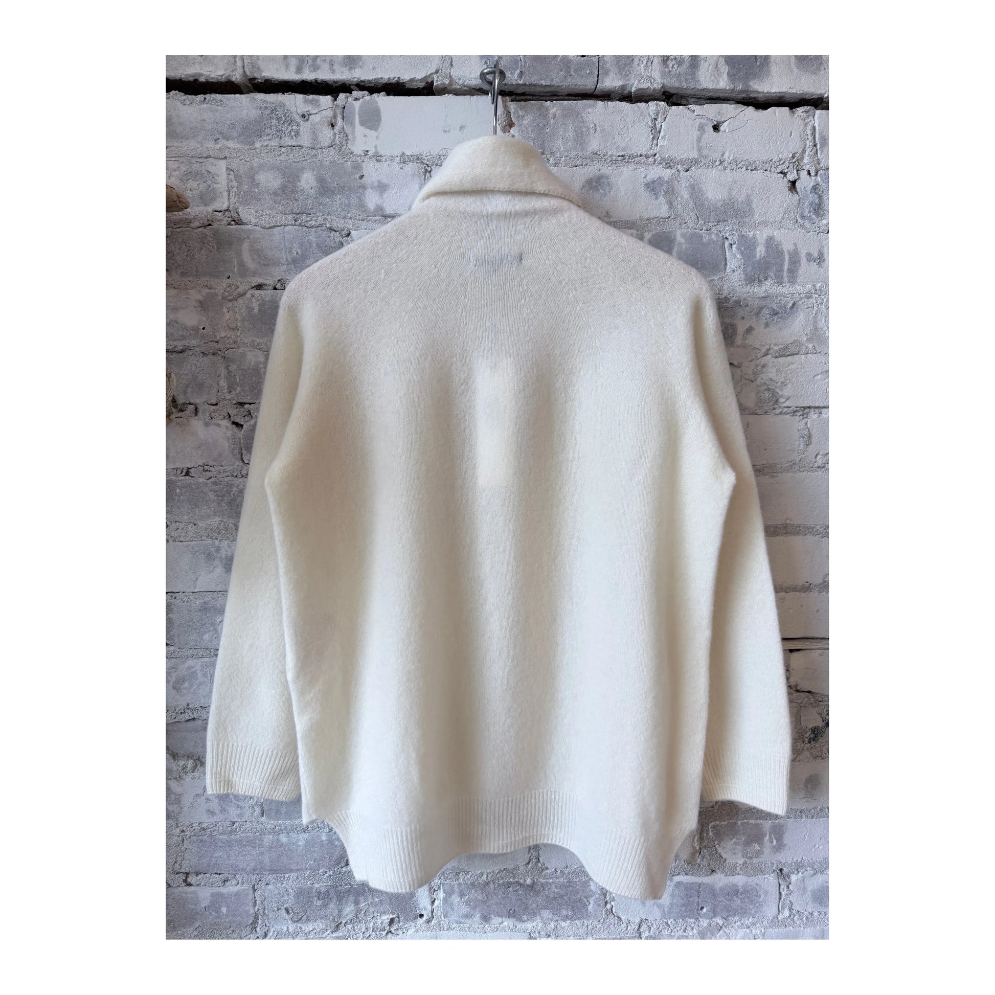 Women's ivory fine wool turtleneck pullover by Pas De Calais, close-up of soft knit fabric and high neckline.