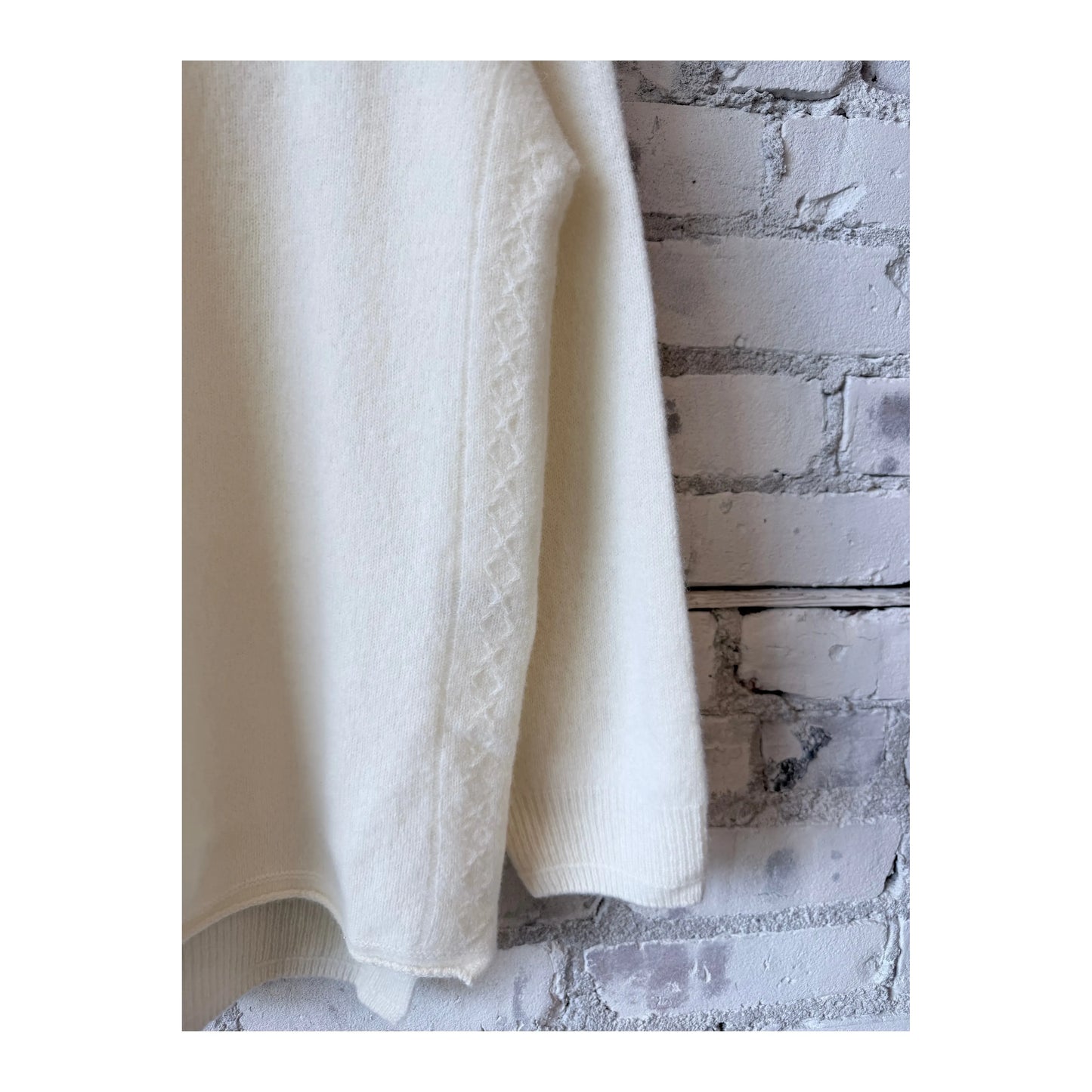 Women’s ivory fine wool turtleneck pullover by Pas De Calais, showing a close-up of the soft, cozy knit fabric.