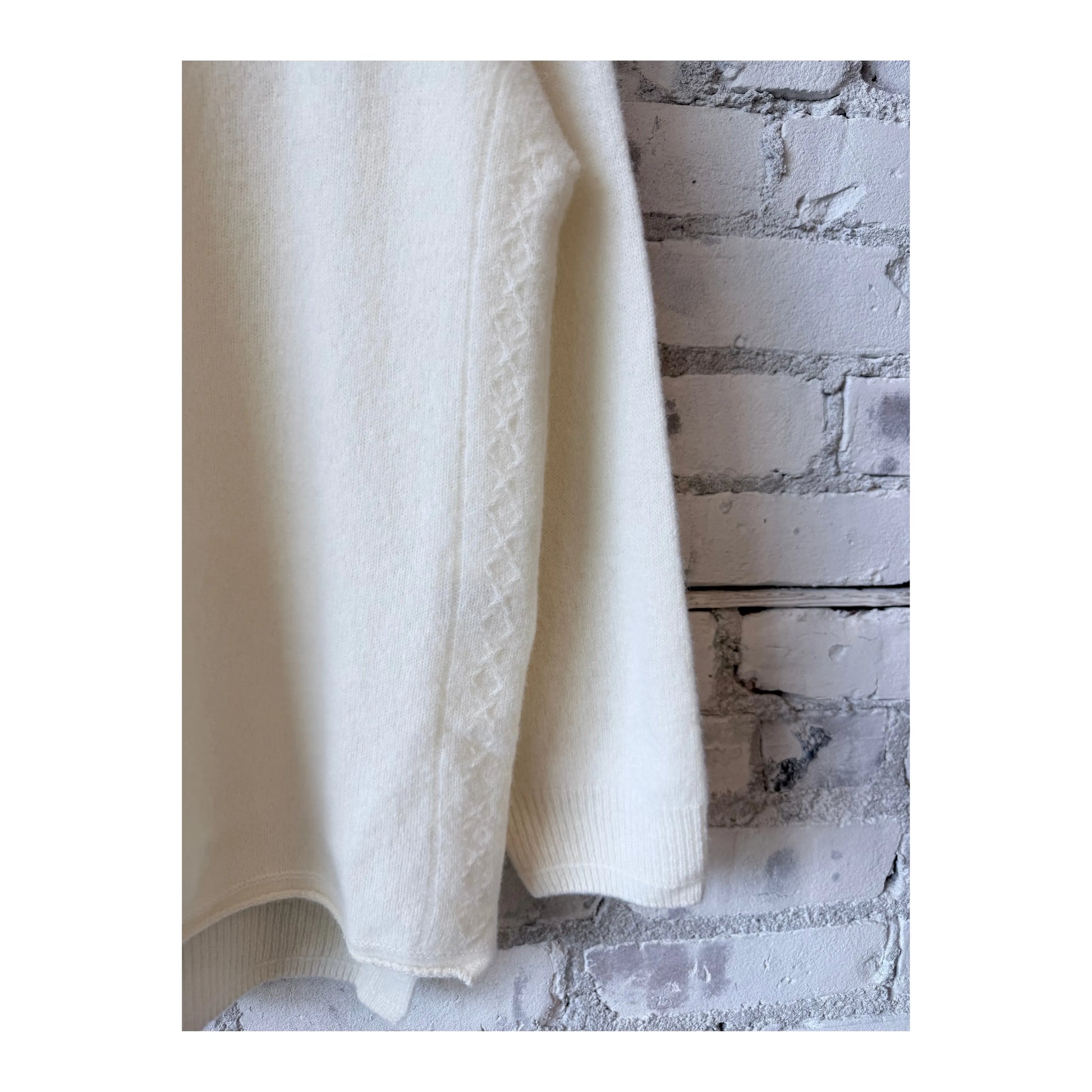 Women’s ivory fine wool turtleneck pullover by Pas De Calais, showing a close-up of the soft, cozy knit fabric.