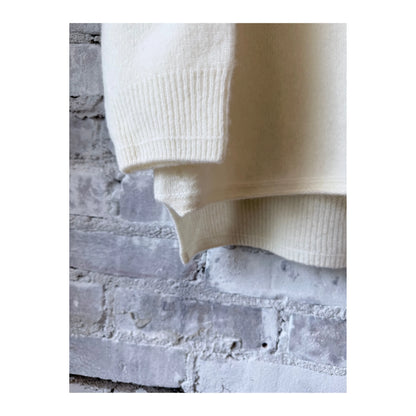 Women's ivory fine wool turtleneck pullover by Pas De Calais, showcasing the cozy, stylish knit fabric and classic fit.