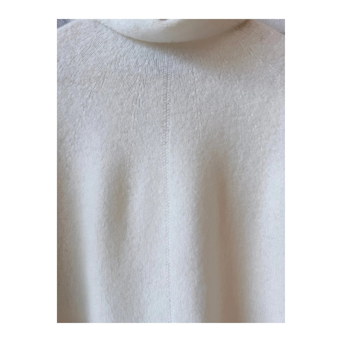 Women's ivory fine wool turtleneck pullover by Pas De Calais, showcasing a close-up of the soft knit fabric and turtleneck collar.