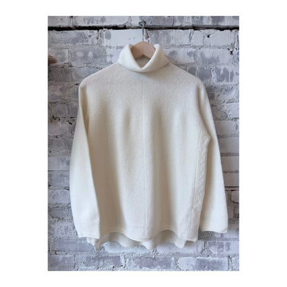 Women's ivory fine wool turtleneck pullover by Pas De Calais, shown on a model with a cozy fit and classic style.