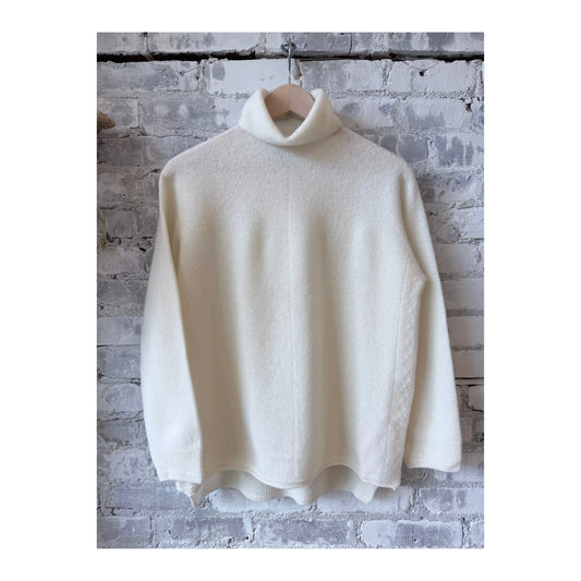 Women's ivory fine wool turtleneck pullover by Pas De Calais, shown on a model with a cozy fit and classic style.