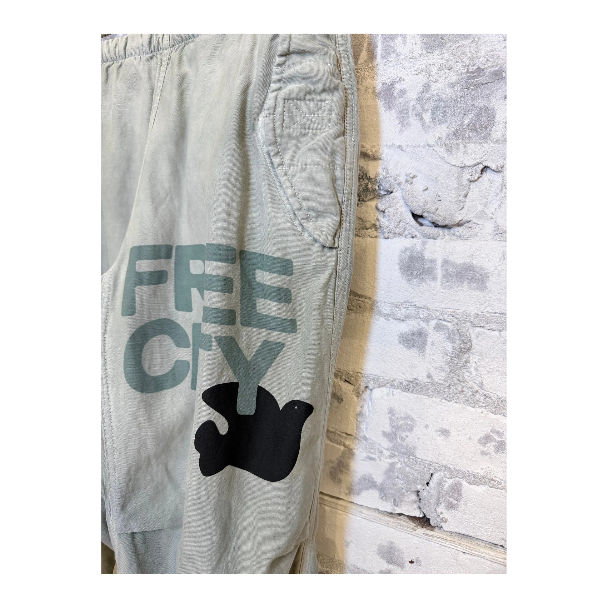 Women's Freecity Airjump Pant in silver matte satin with flap-free and snap-free design, shown on a model.
