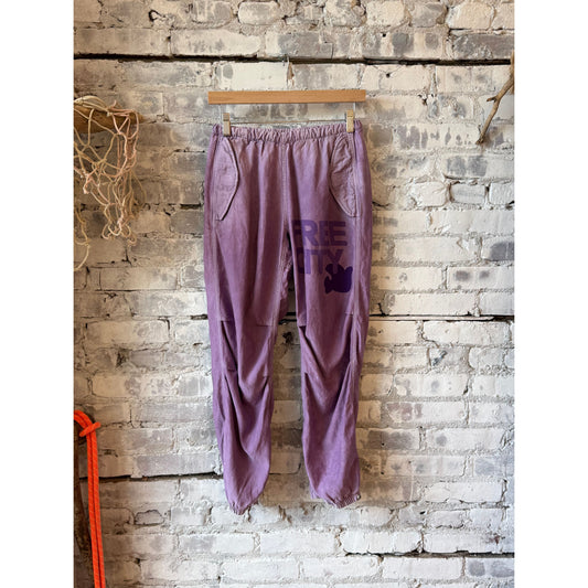 Women's Freecity Airjump Pant in matte satin, large flap and snap detail, in Bloom color, casual and stylish activewear.