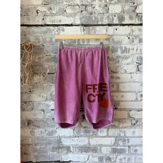 Women's Freecity matte satin back pocket shorts in Pinkshroom Powder, showing the stylish fabric and pocket details.