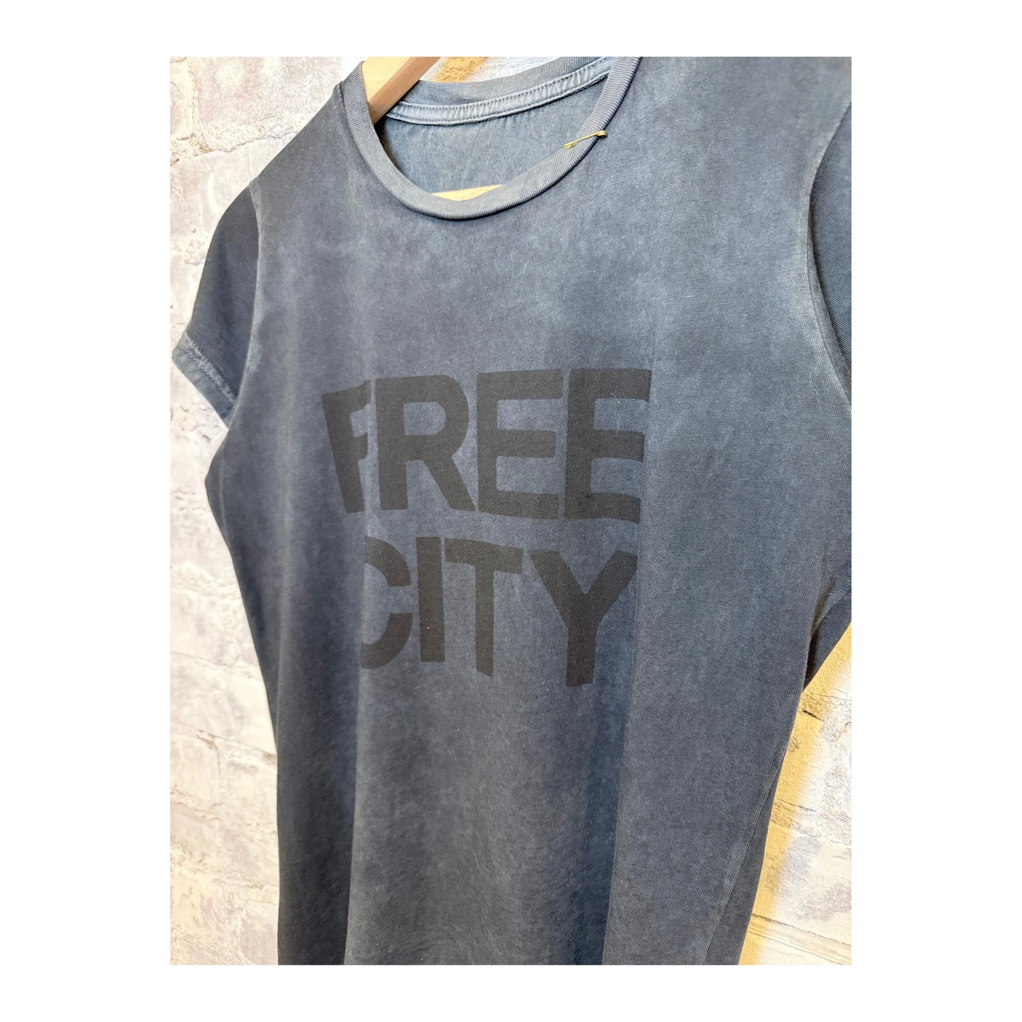Women's Freecity "the doing of it is the being of it" vintage-style short sleeve tee in volcano powder, featuring a relaxed fit and graphic print.