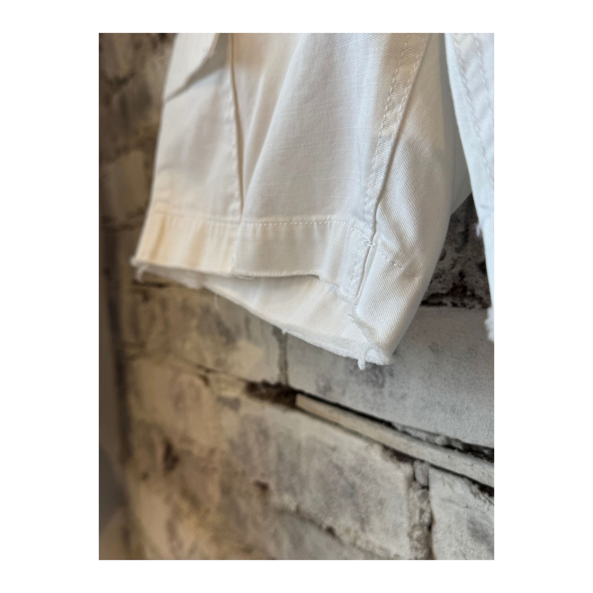 Women’s white surplus cargo shorts by G1 Women’s, featuring multiple pockets and a relaxed fit, shown on model.