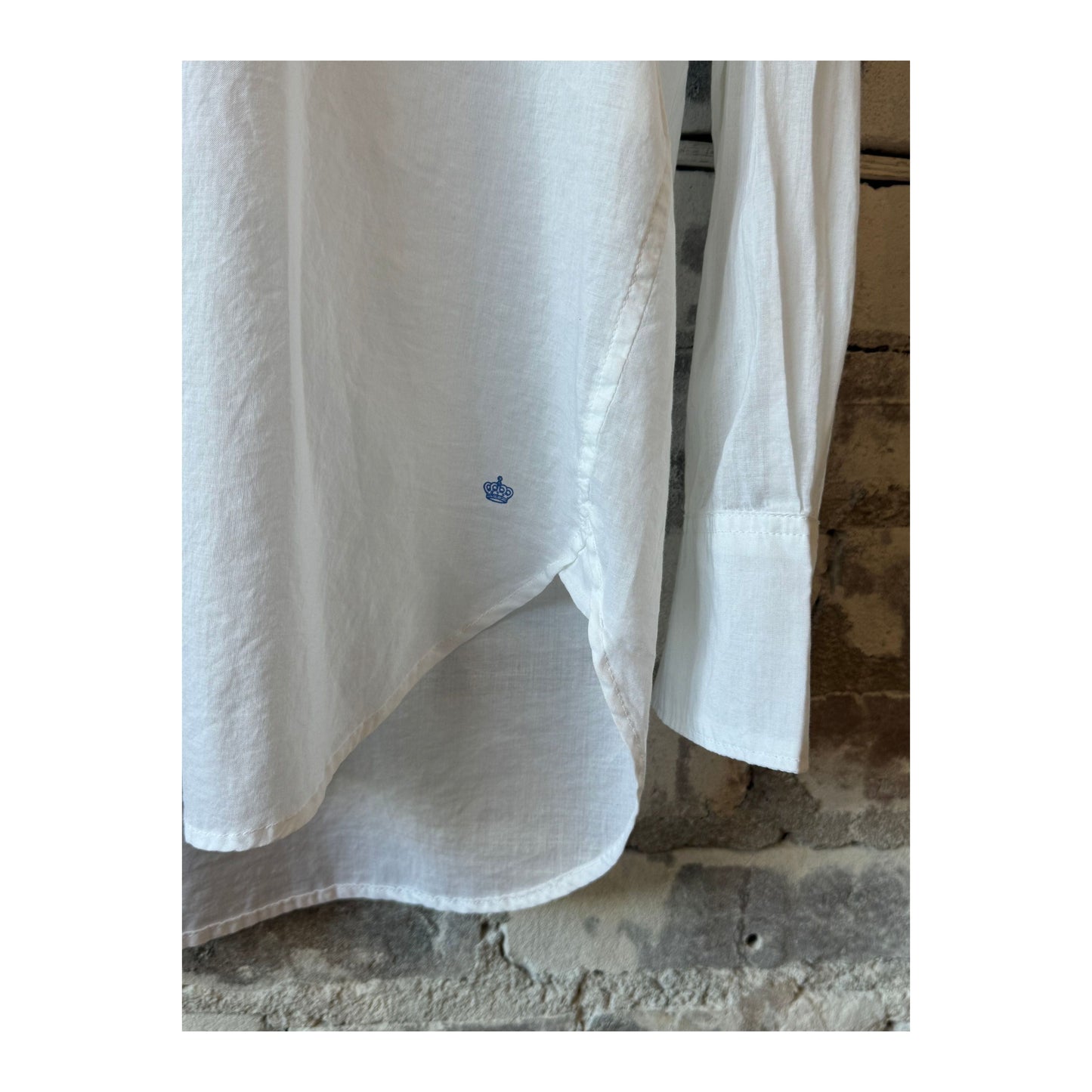 White women's Airy Shirt by G1 Women's, lightweight and breathable, shown hanging on a wooden hanger.