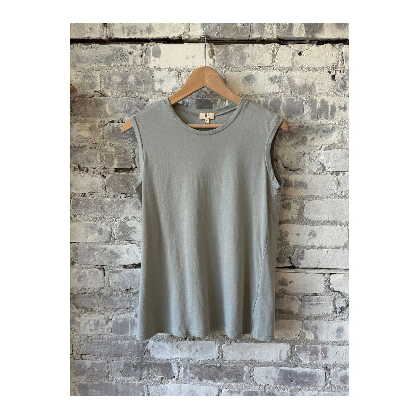 Women's sage muscle tank top by G1 Women's, sleeveless design with a relaxed fit, perfect for workout or casual wear.