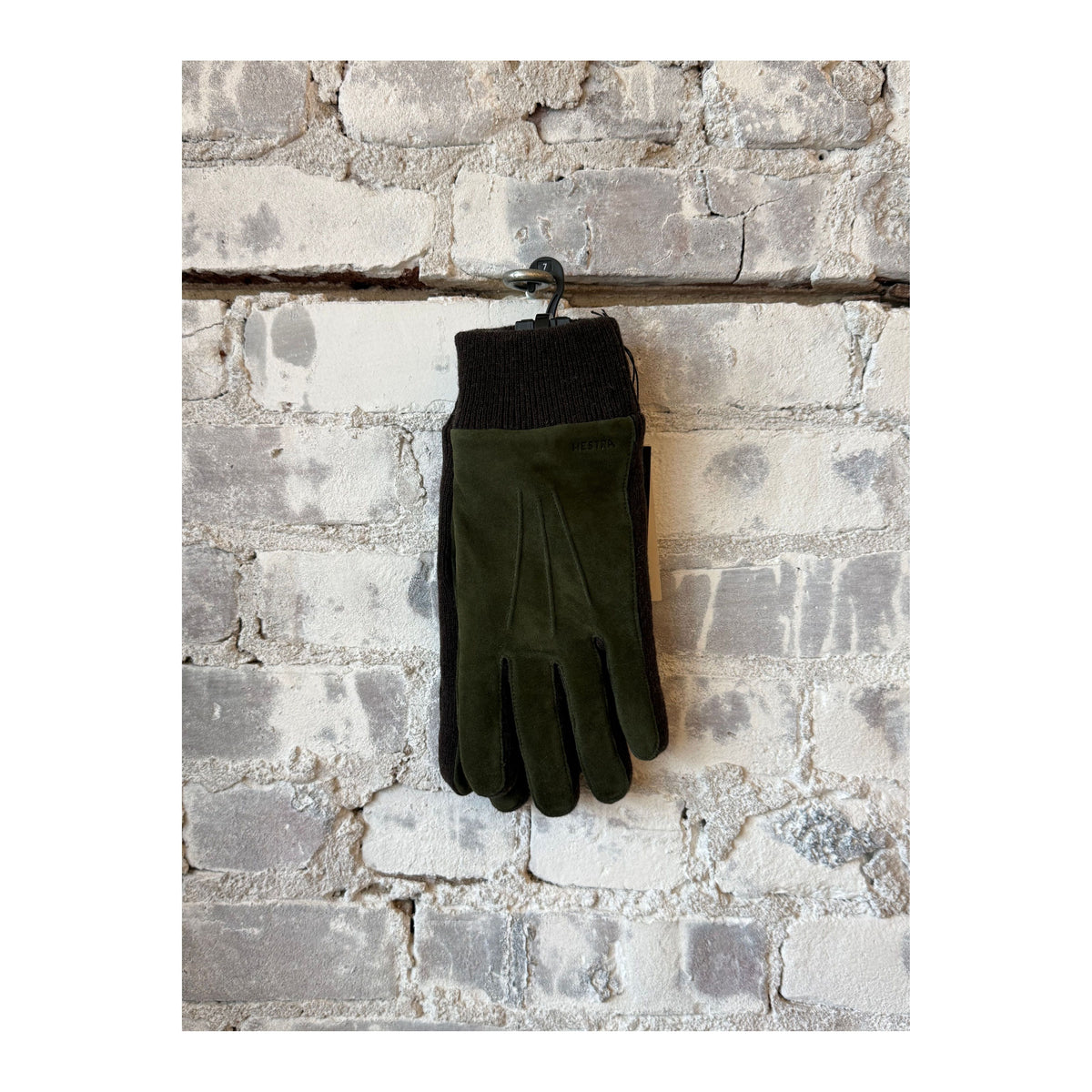 Men's Hestra Geoffrey Glove in dark olive, showing a close-up of the stylish leather glove with detailed stitching and soft lining.