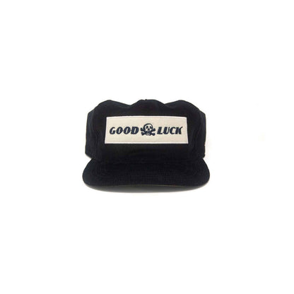 Black snapback hat with "Good Luck" embroidered patch, branded by The Ampal Creative, accessories, casual headwear.