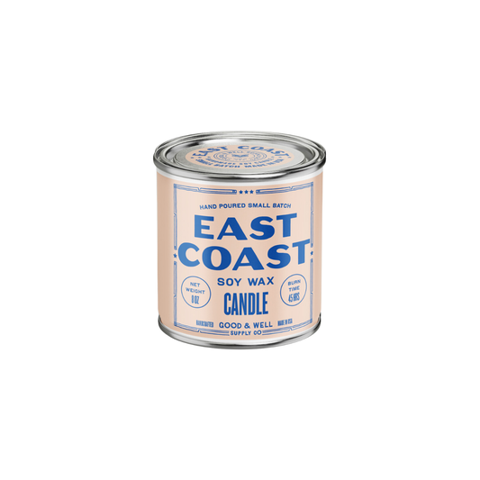East Coast Soy Candle from Good & Well Supply Co. in a glass jar, with a lit wick and soft glow, perfect for home ambiance.