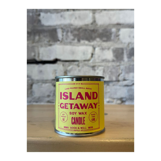 Island Getaway soy candle from Good & Well Supply Co., featuring a glass jar with a tropical-themed label and white wax.