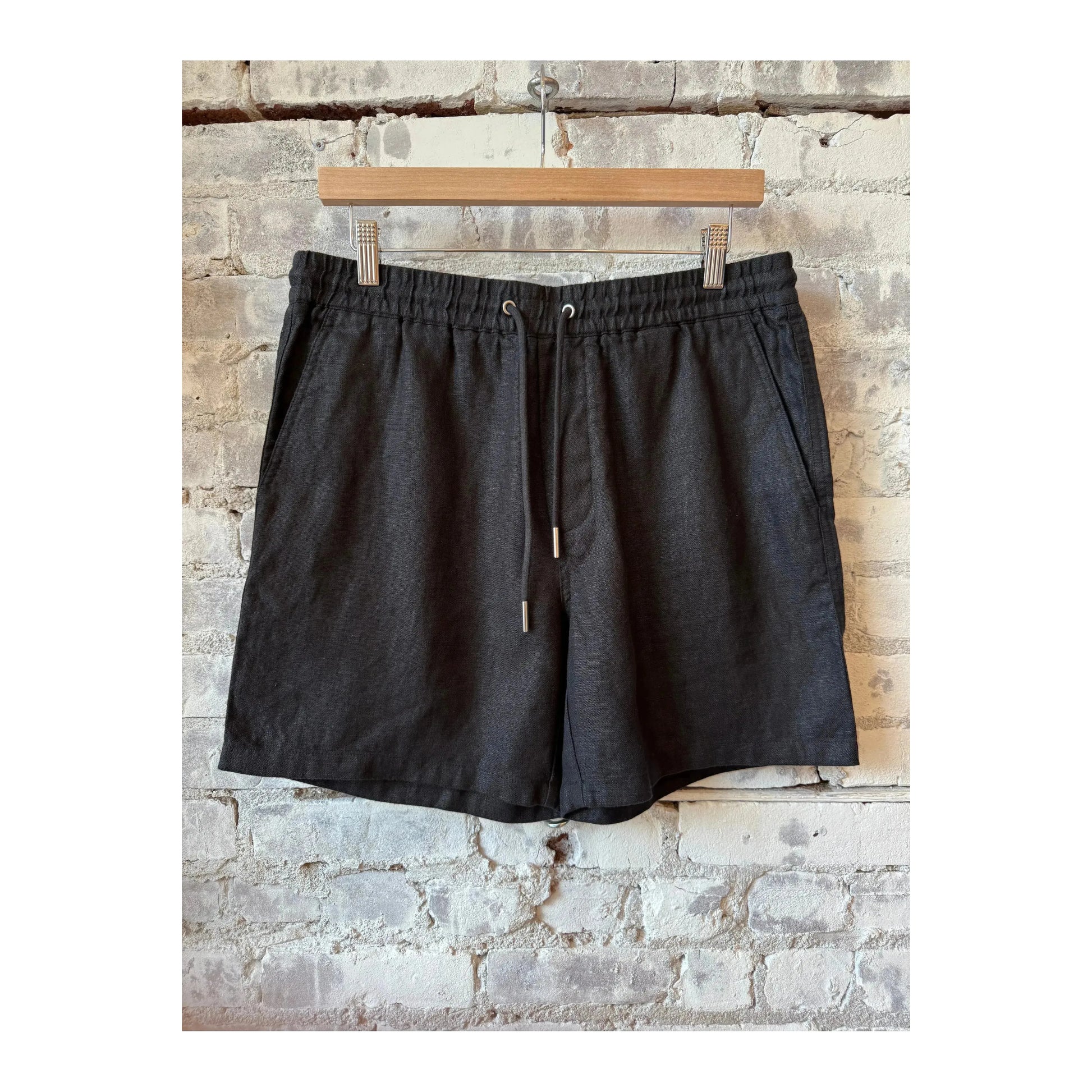 Men's black linen shorts with drawstring waist by NN07, casual style, shown on a model.