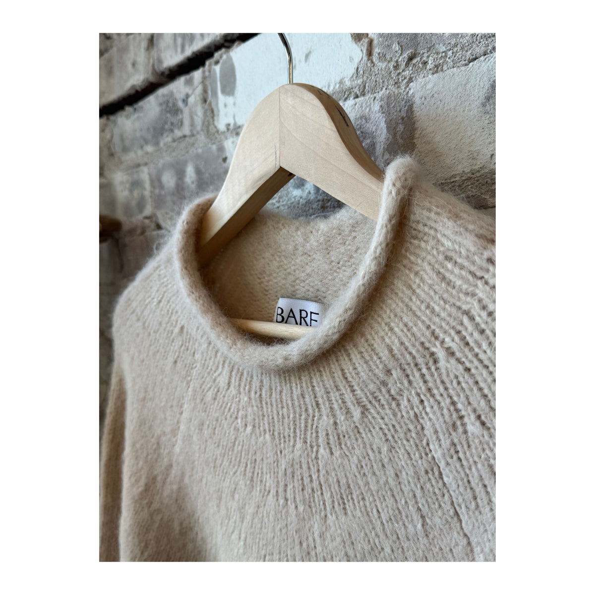 Women's cream handloom rollneck sweater by Bare Knitwear, featuring a cozy knit texture and classic fit.