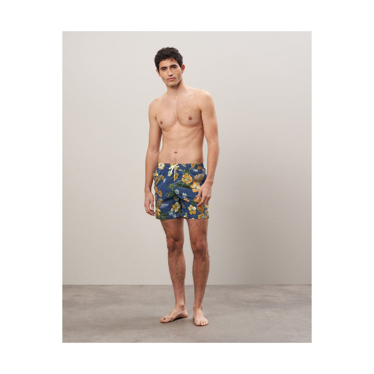Men's navy swim trunks with hibiscus print made from recycled nylon by Hartford Men's, featuring a comfortable fit and vibrant design.
