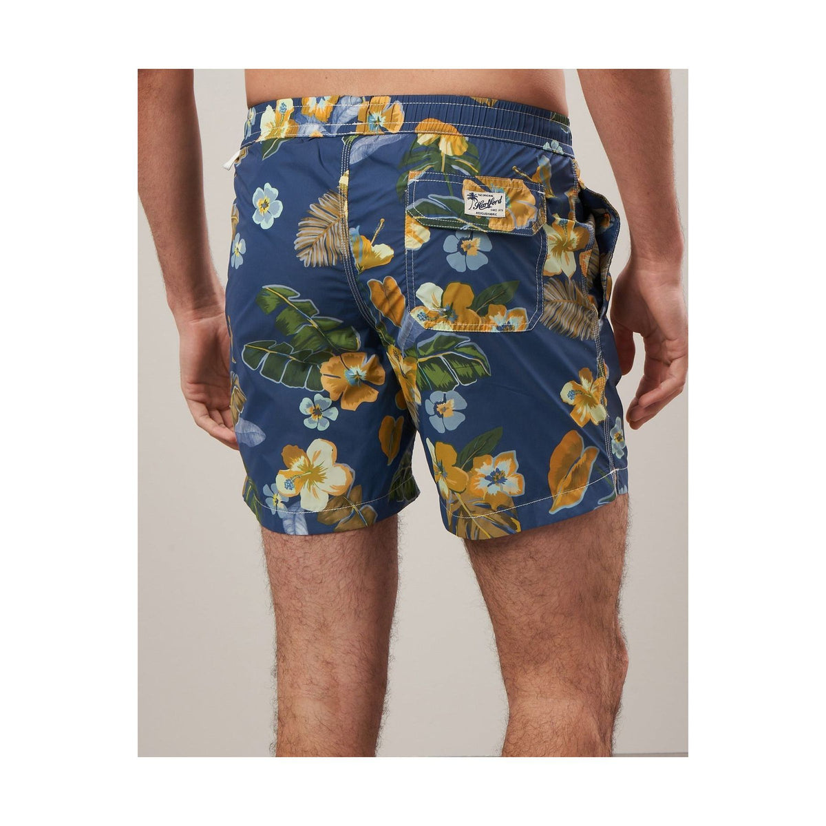 Men's navy swim trunks with hibiscus print made from recycled nylon, by Hartford Men's.