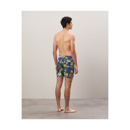 Men's navy swim trunks with hibiscus print made from recycled nylon by Hartford Men's, featuring a relaxed fit and drawstring waist.
