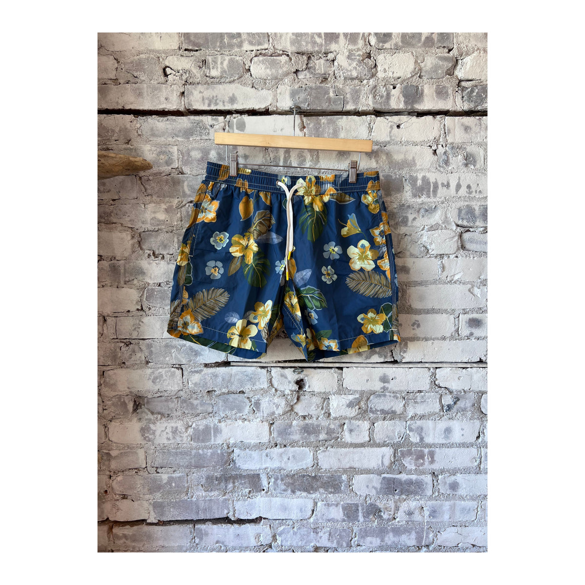Men's navy swim trunks with hibiscus print made from recycled nylon by Hartford Men's, featuring a stylish tropical design.
