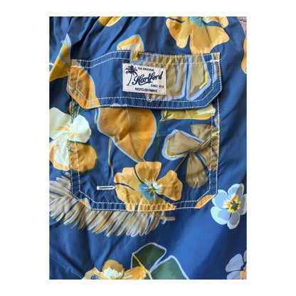 Men's navy Hibiscus printed swim trunks by Hartford Men's made from recycled nylon, featuring vibrant floral design.