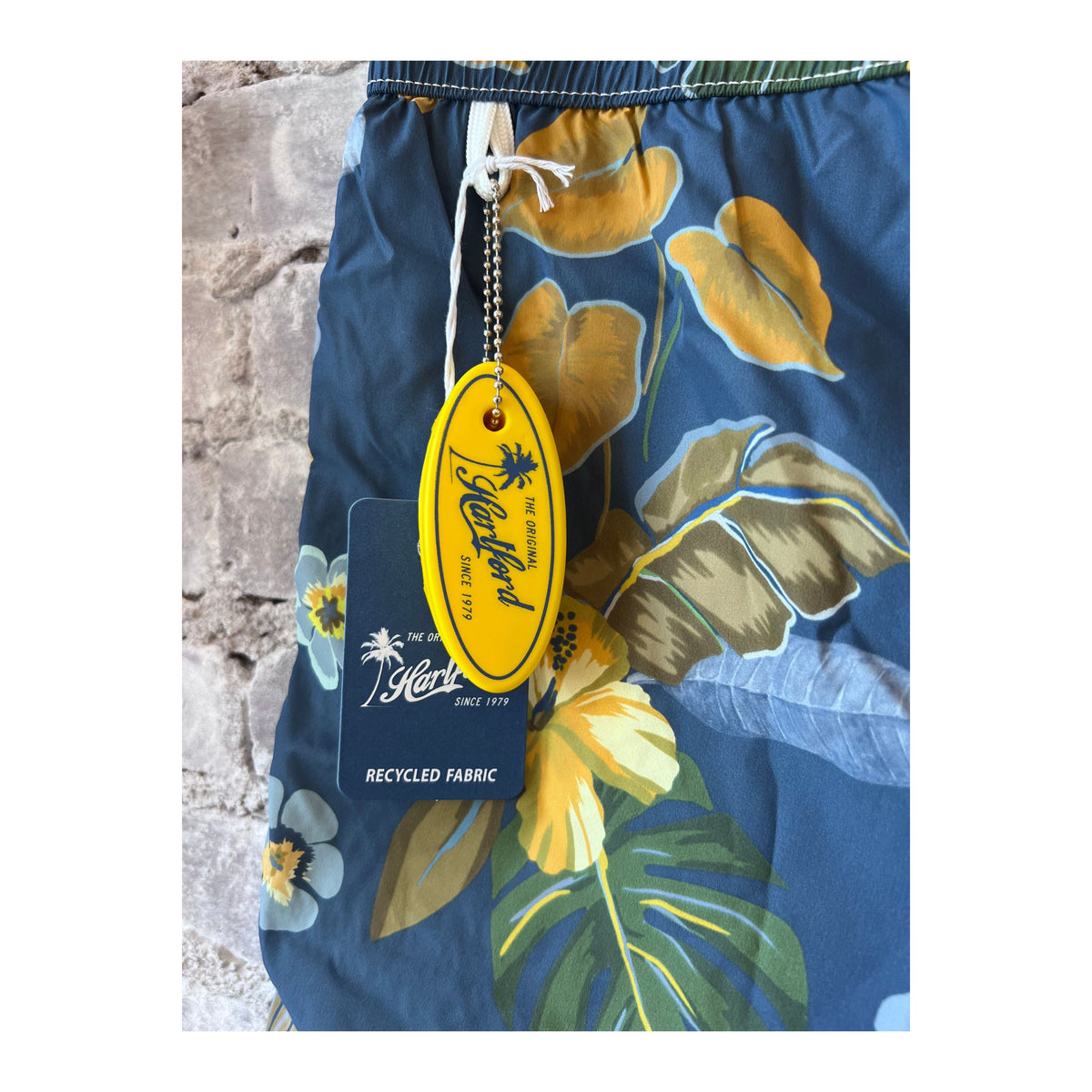 Men's navy swim trunks with hibiscus print made from recycled nylon by Hartford Men's, featuring a comfortable fit and vibrant floral design.