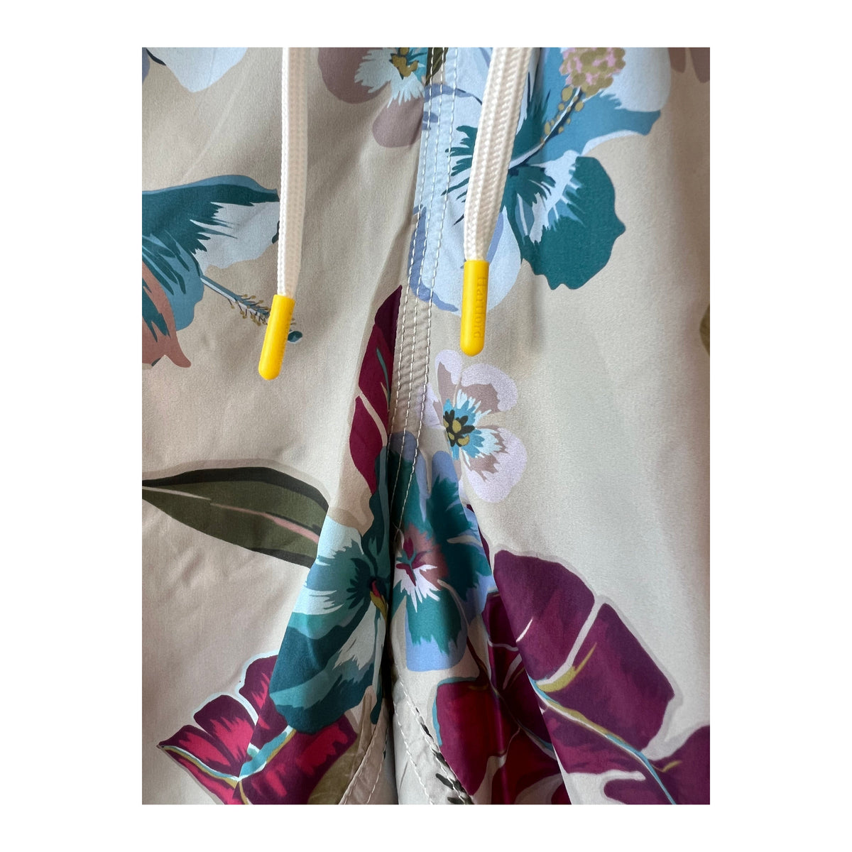 Men's Hartford Hibiscus printed recycle nylon swim trunks in sand with vibrant hibiscus design, suitable for beach or poolwear.
