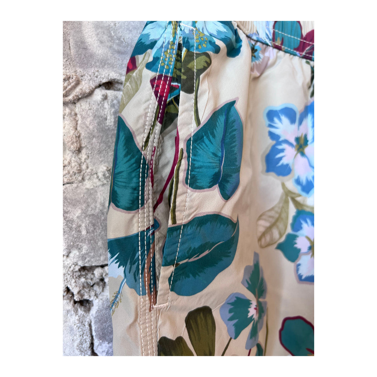 Men's Hartford Hibiscus printed recycle nylon swim trunks in sand color, featuring vibrant hibiscus design and adjustable waistband.