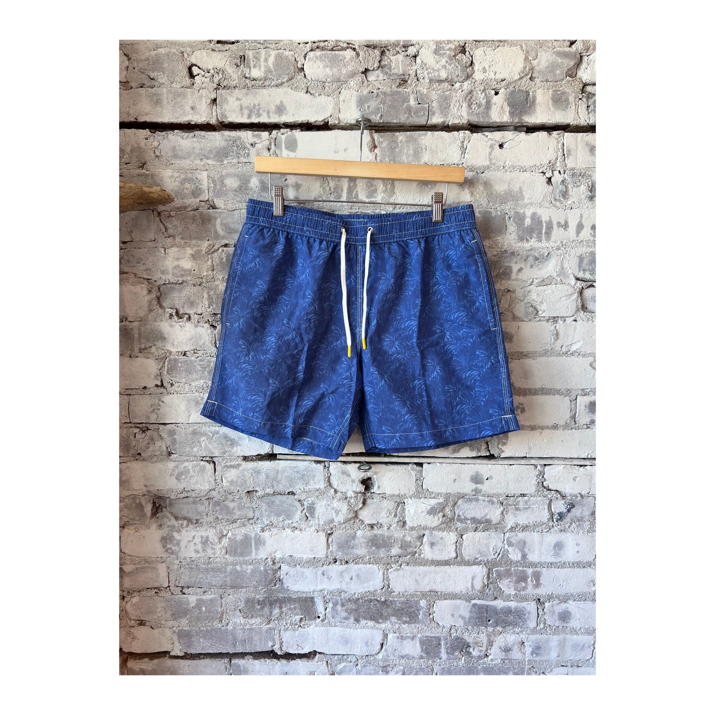 Men's Hartford blue nylon swim trunks with palms print, featuring a relaxed fit and adjustable waistband for beach or poolside wear.