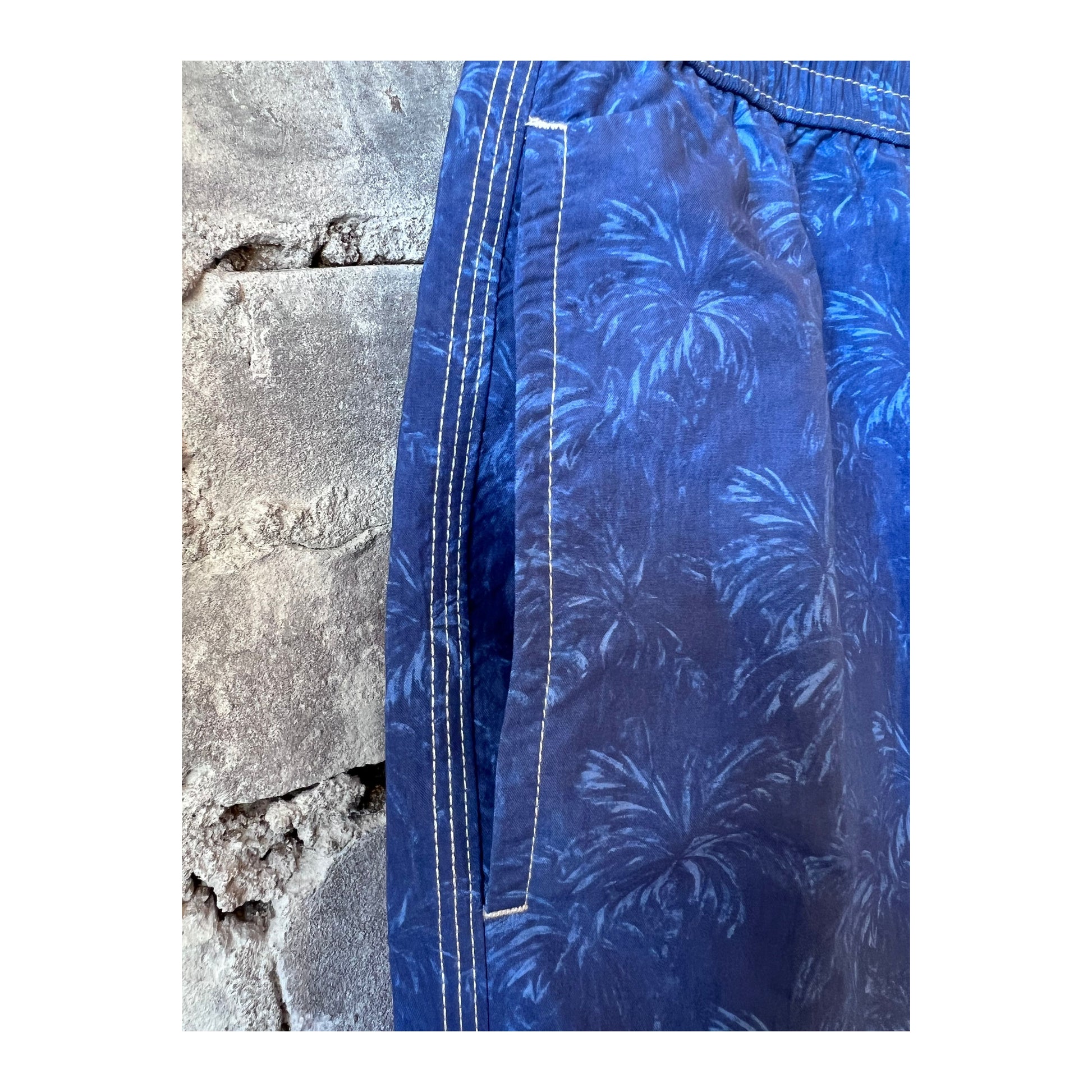 Hartford Men's blue nylon swim trunks with palm print, casual swimwear for men, featuring vibrant tropical palm design.