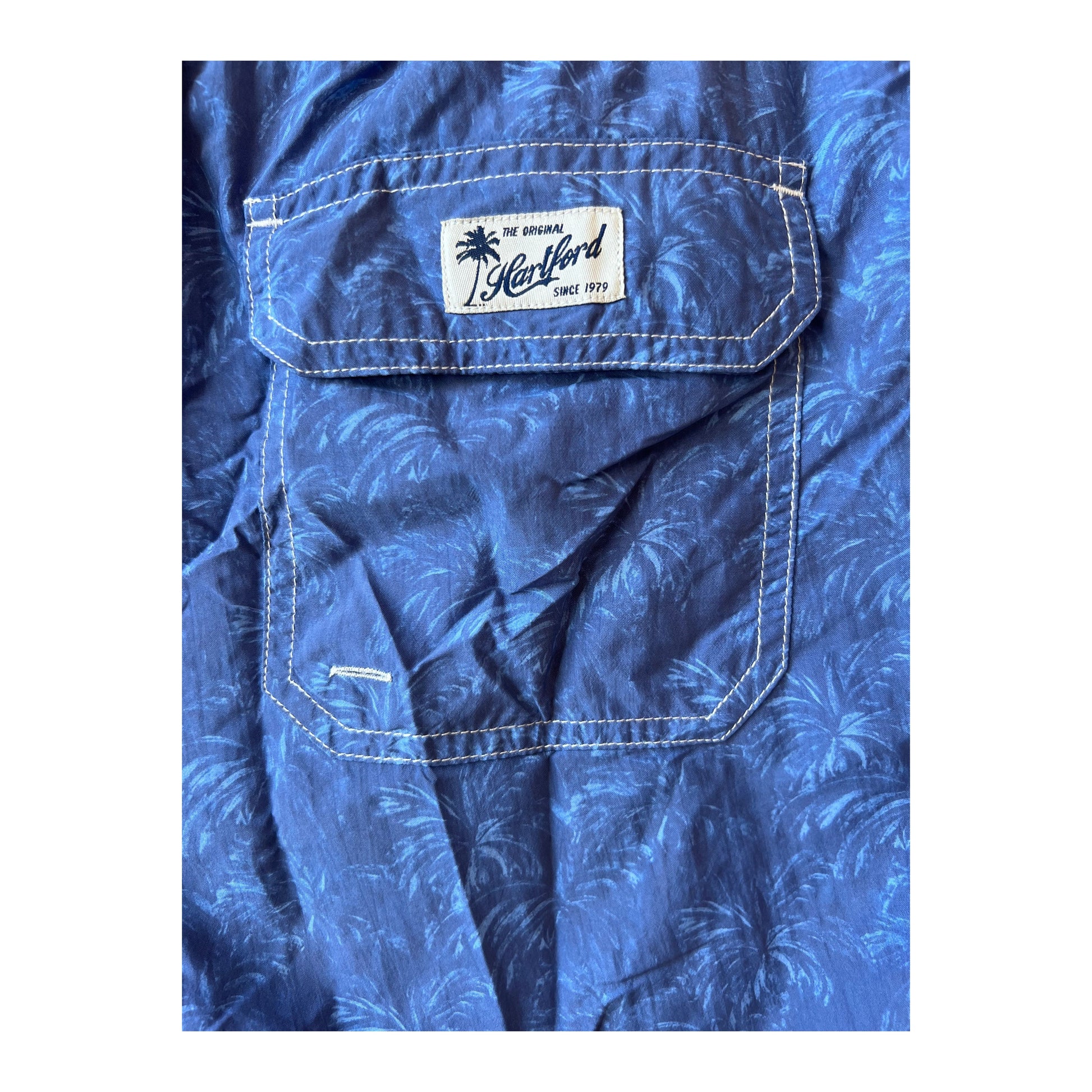 Men's Hartford nylon swim trunks with a blue palms print, featuring a comfortable fit and elastic waistband.