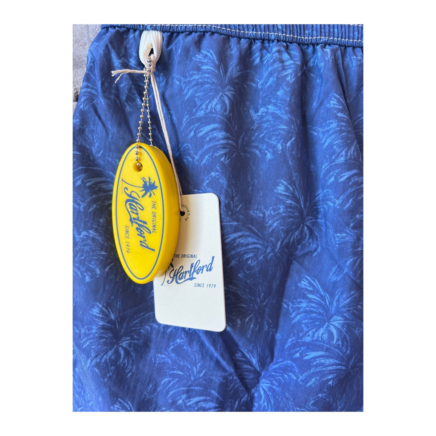 Men's Hartford Palms Print Nylon Swim Trunks in blue, featuring a vibrant tropical palm print and comfortable fit.