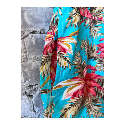 Men's turquoise printed swim trunks by Hartford Men's featuring vibrant tropical patterns and comfortable fit.