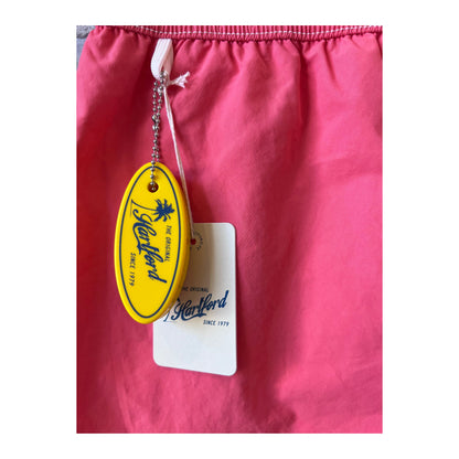 Men's Hartford Classic Swim Trunks in faded coral with matching pochette, featuring a relaxed summer style.