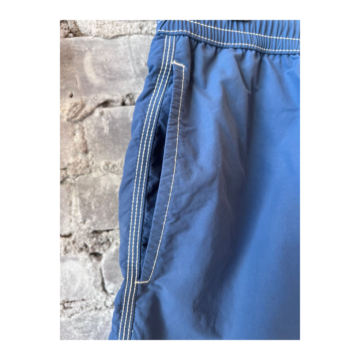 Men's Hartford Nautic Blue swim trunks with matching pochette, featuring classic design and comfortable fit.