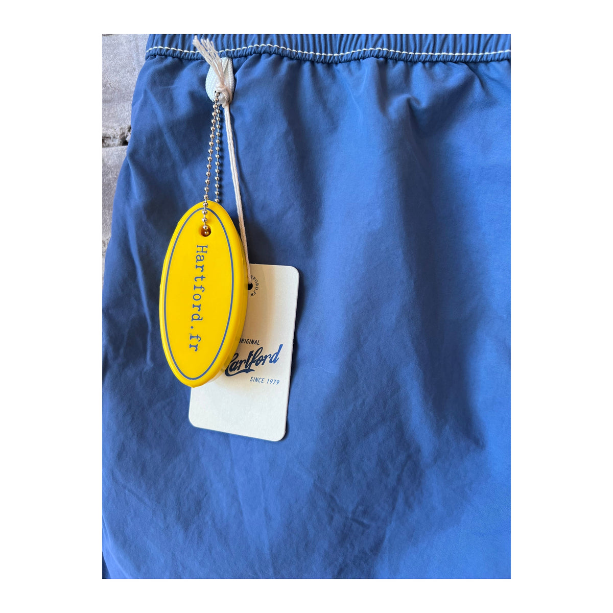 Men's Hartford Nautic Blue swim trunks with matching pochette, casual summer swimwear and accessories.