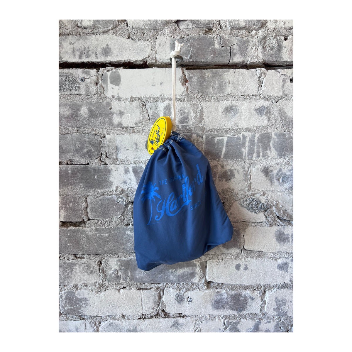 Men's Hartford Nautic Blue classic swim trunks with matching pochette, stylish and comfortable for beach or poolside wear.