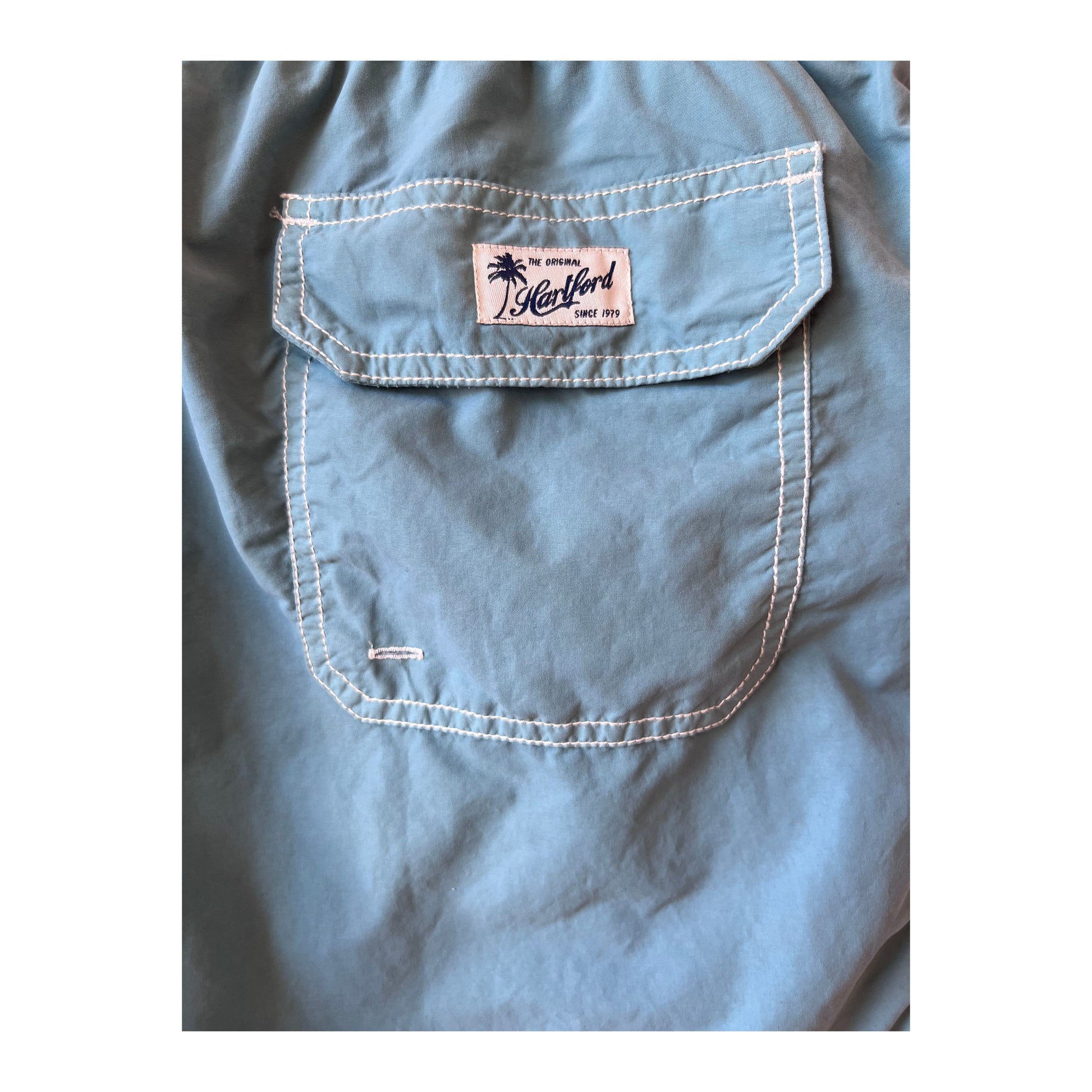 Men's classic swim trunks and matching pochette in sage from Hartford Men's, featuring a comfortable fit and stylish design.