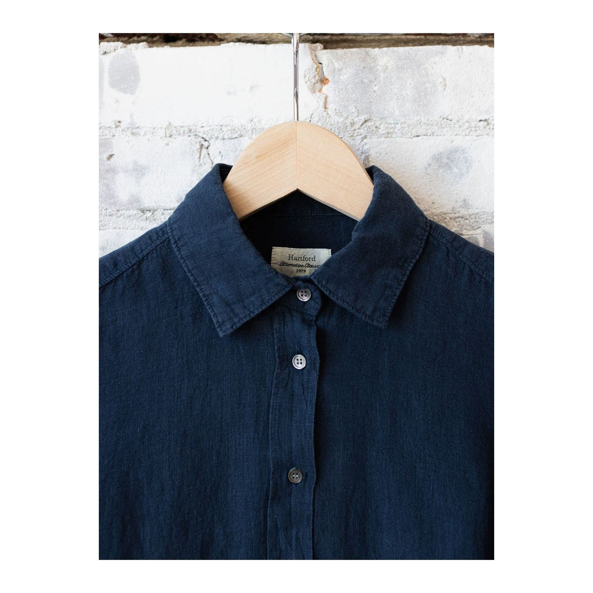 Navy women's Coraz linen shirt by Hartford Women's with button-up front and long sleeves, displayed on a hanger.