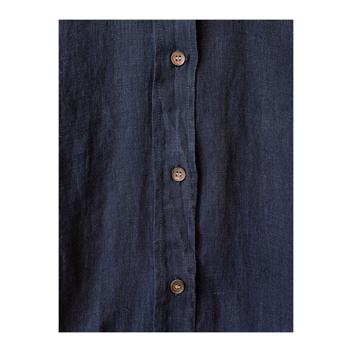 Navy women's Coraz Linen Shirt by Hartford Women's with button-up front and long sleeves, hanging on a hanger.