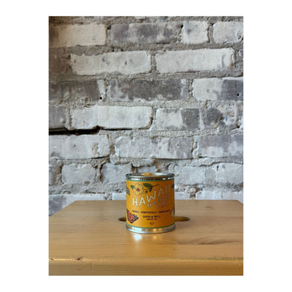 Hawaii State soy candle by Good & Well Supply Co. in a glass jar, showcasing a tropical design on the label.