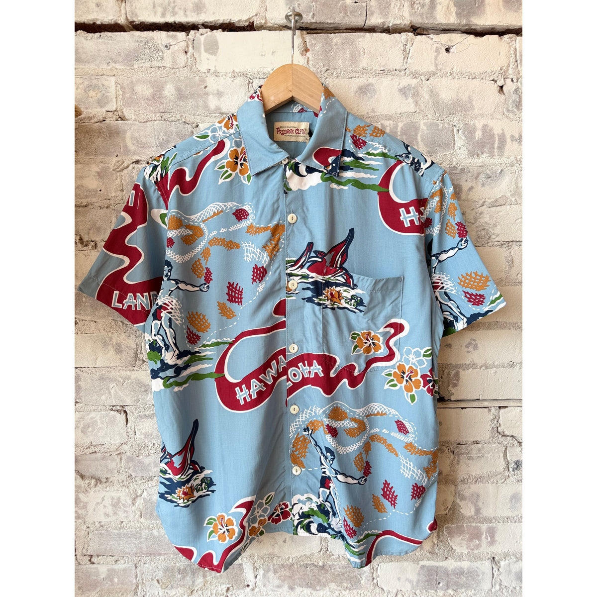 Men's Hawaiian Aloha shirt in clear blue by Freenote Cloth, featuring tropical floral print and short sleeves.